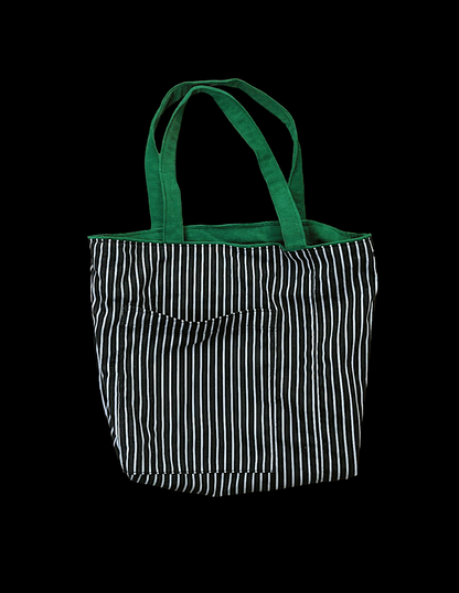 A black and white striped tote bag on a black background.