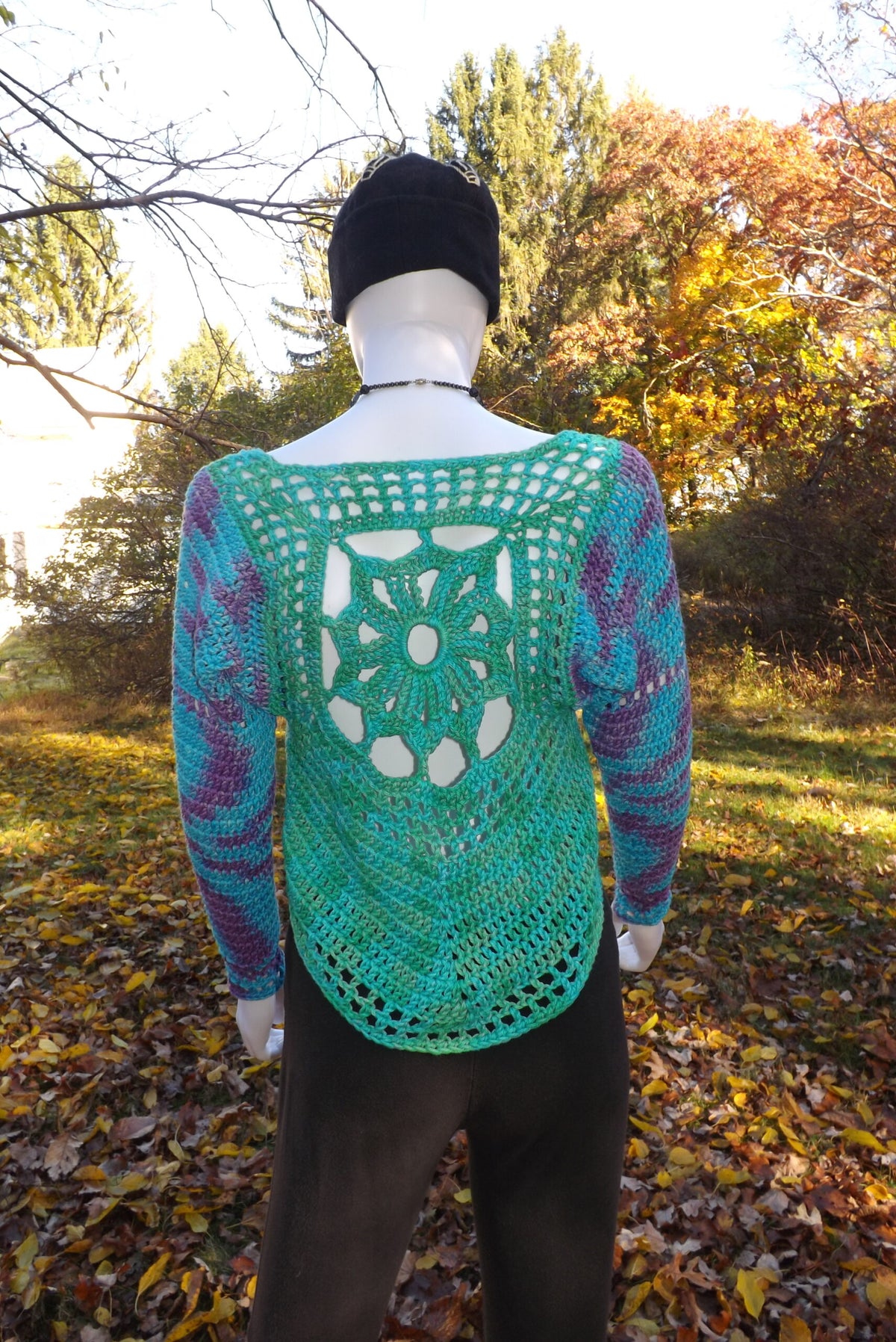 Organic cotton crochet sweater with sun design on back.