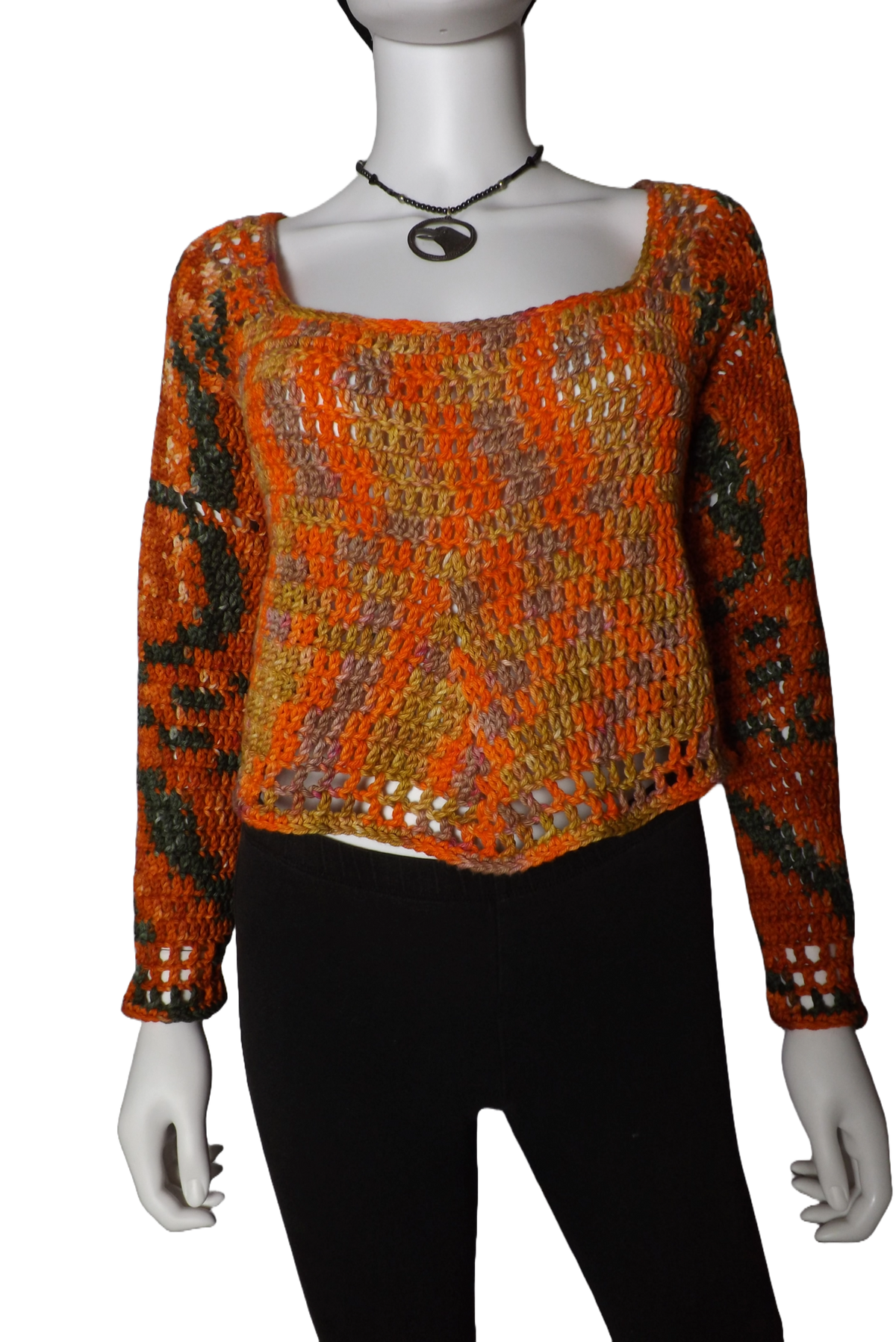 A loose fitting crochet sweater with long sleeves in green, yellow and orange colors.
