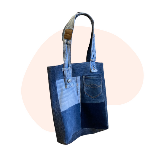 A blue denim tote bag on a white background.