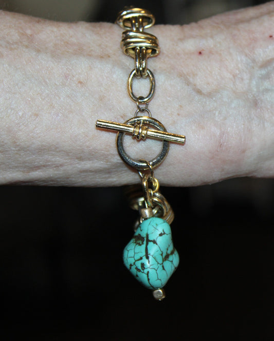 A bracelet on a person's wrist.