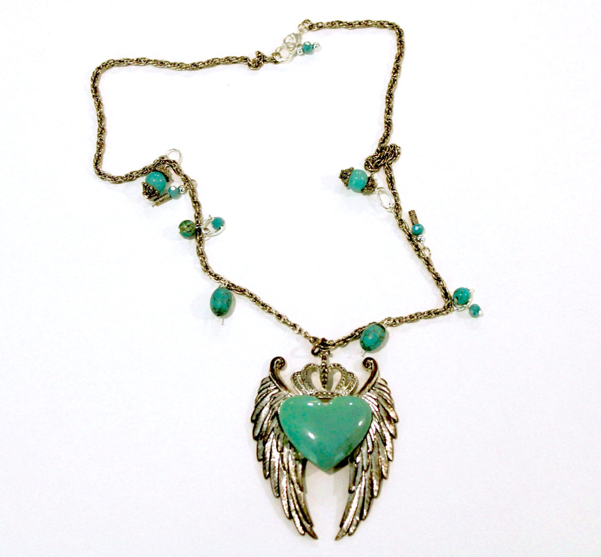 A necklace with an angel wing and turquoise beads.