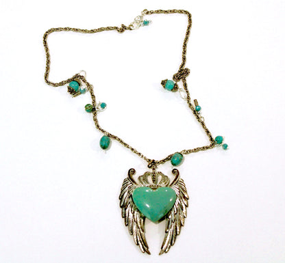 A necklace with an angel wing and turquoise beads.