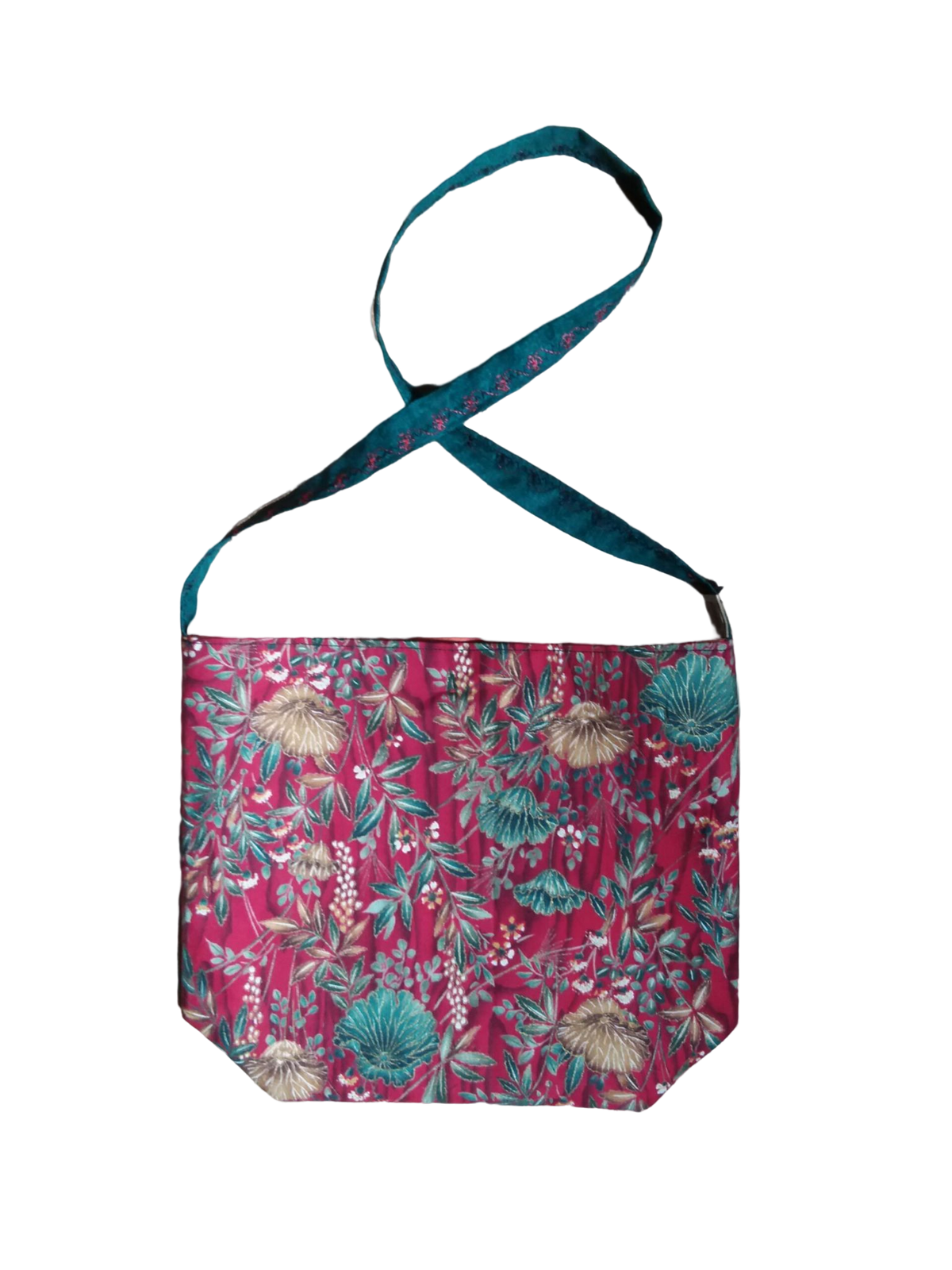 A red bag with a floral pattern on it.