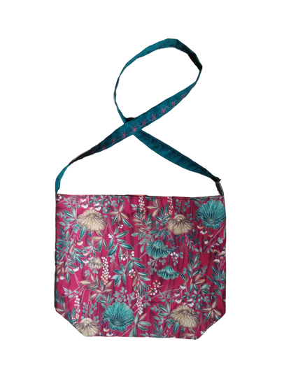 A red bag with a floral pattern on it.