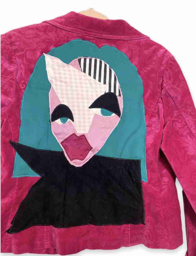 a pink jacket with a picture of a woman's face on it.