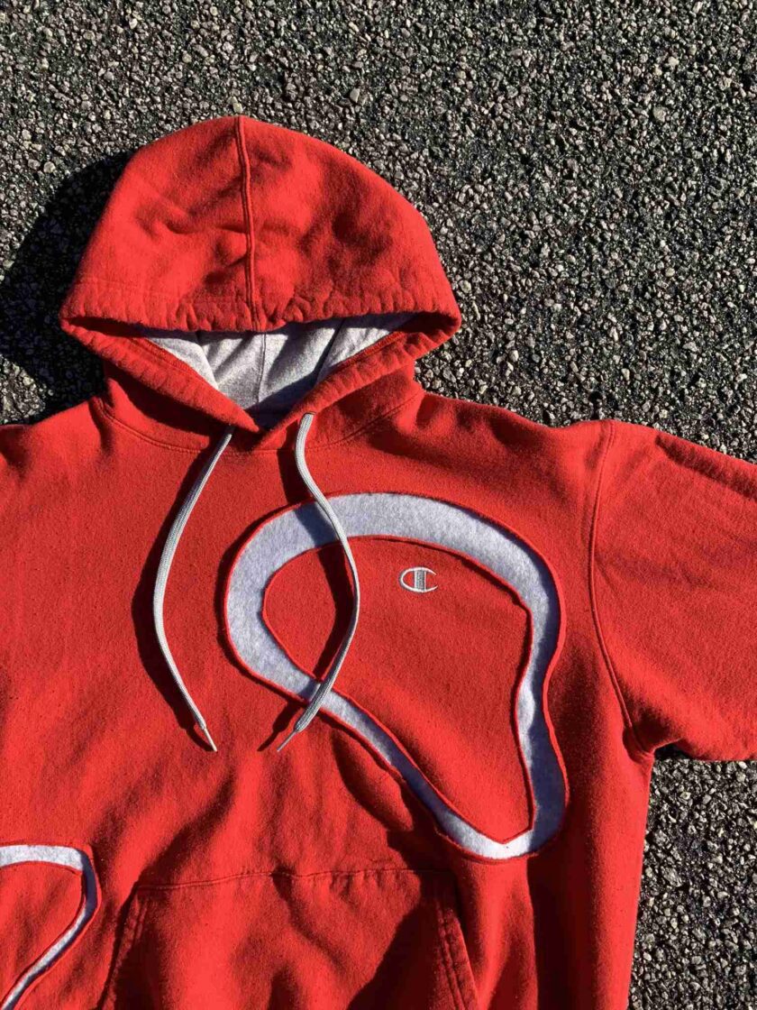 a red sweatshirt with a white logo on it.