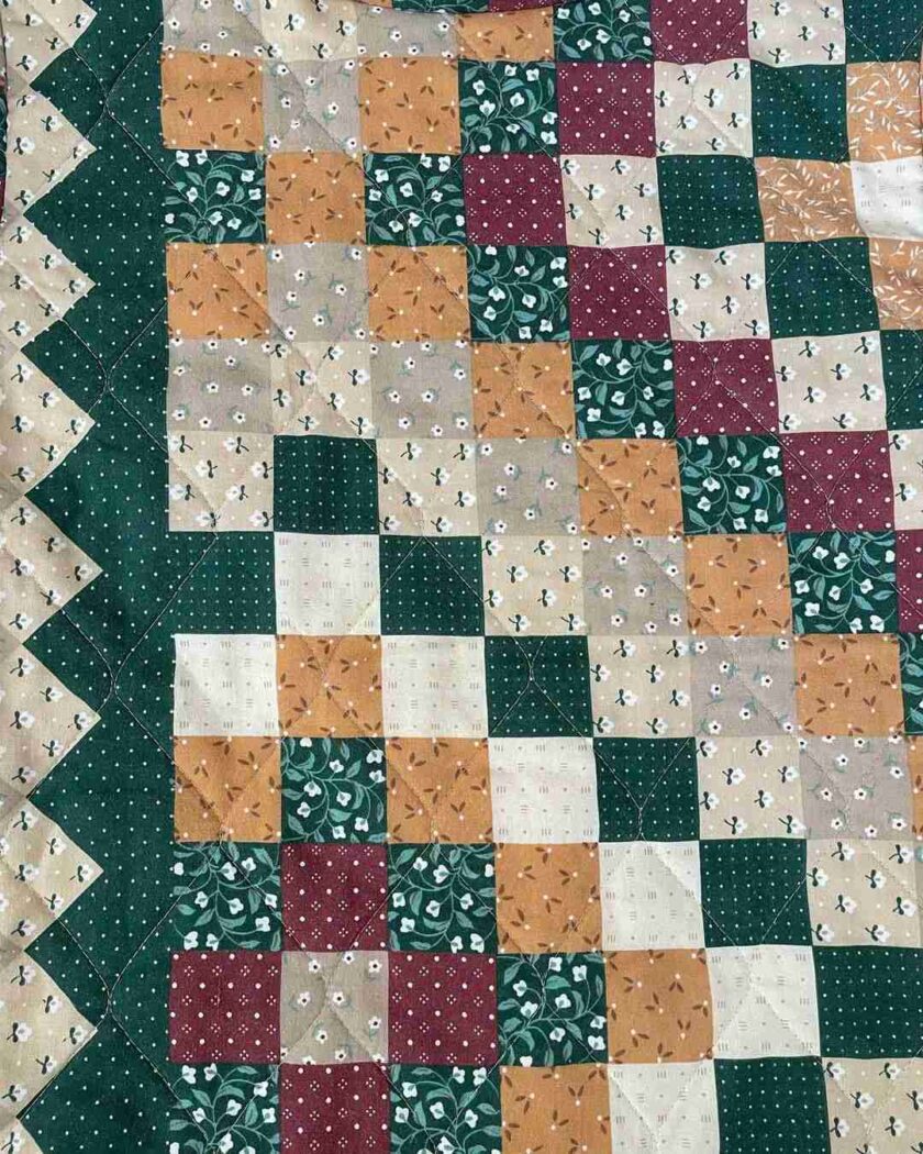 a close up of a quilt on a table.