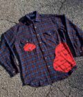 a plaid shirt with a red heart on it.