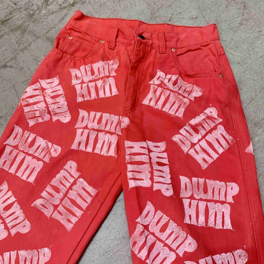 a pair of red pants with white writing on them.