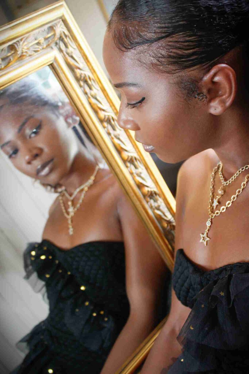 a woman looking at herself in a mirror.