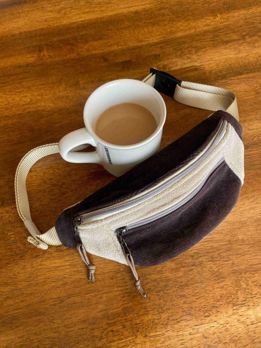 a cup of coffee and a purse on a table.