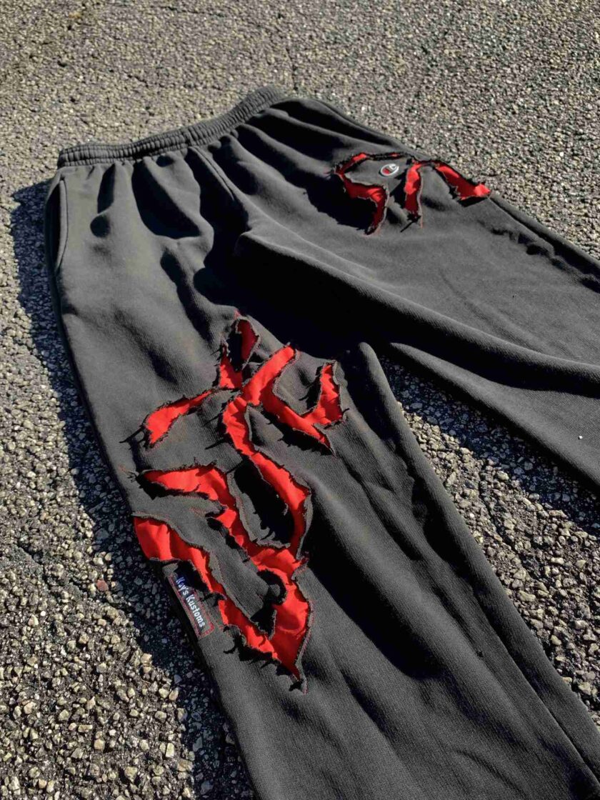 a pair of black pants with red ribbons on them.