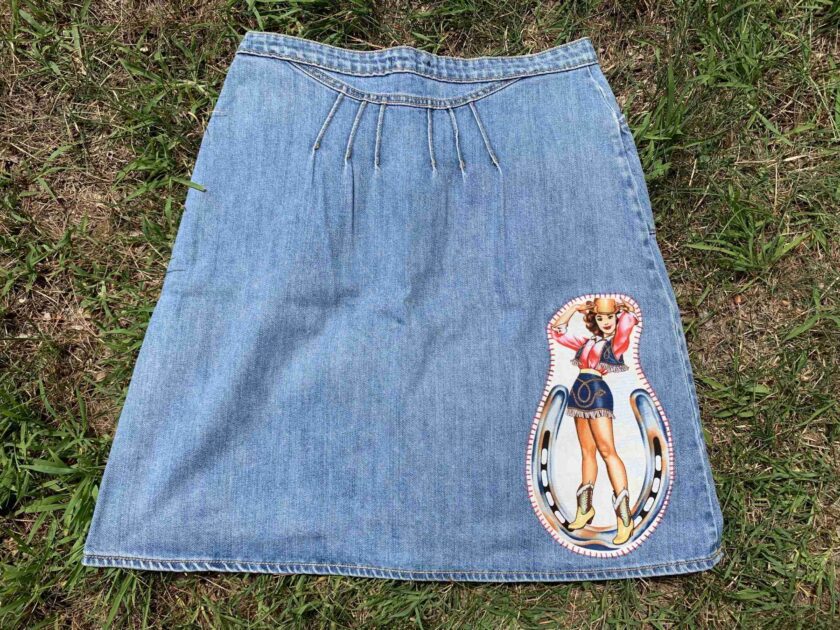 a blue jean skirt with a picture of a woman on it.