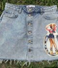 a jean skirt with a pin up girl on it.