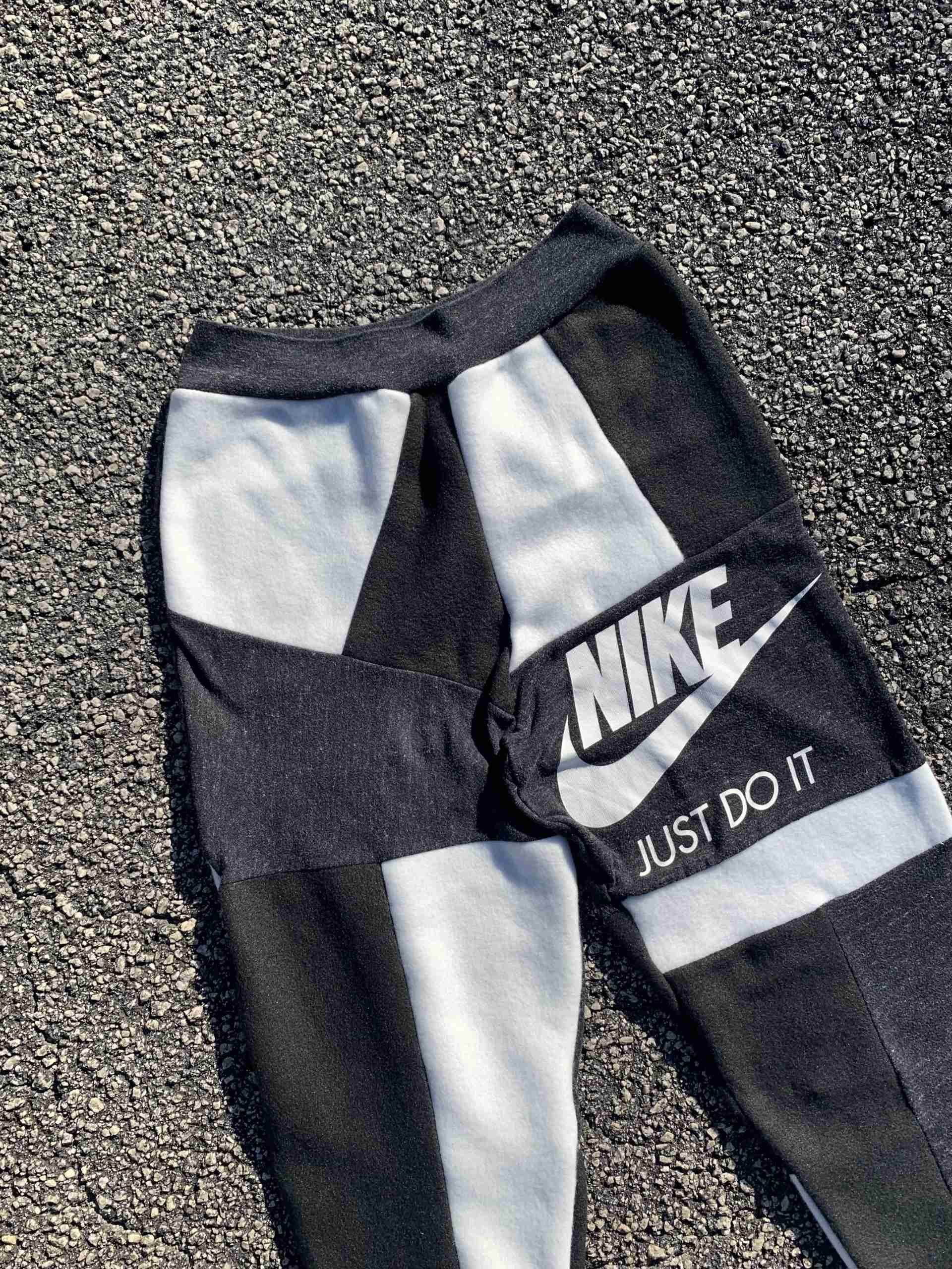 a pair of nike sweatpants laying on the ground.