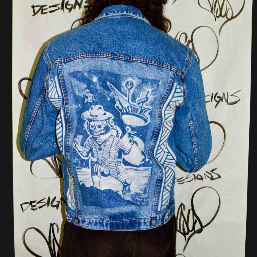 a person wearing a jean jacket with a picture on it.