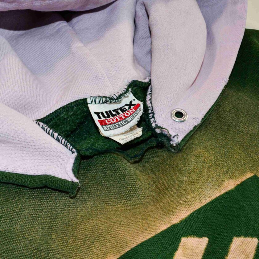 a close up of a green and white shirt.
