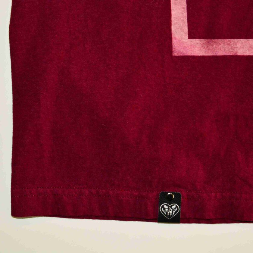 a red towel with a white square on it.