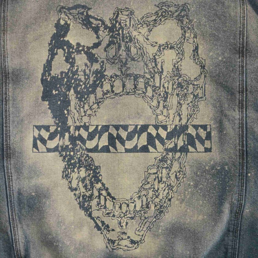 the back of a jean jacket with a picture of a heart on it.