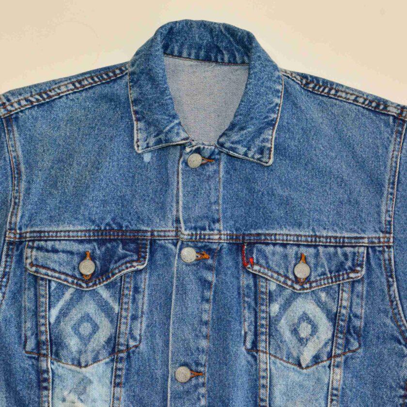 a blue jean jacket with a diamond pattern on it.
