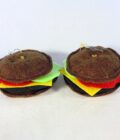 a couple of stuffed hamburgers sitting on top of a white table.