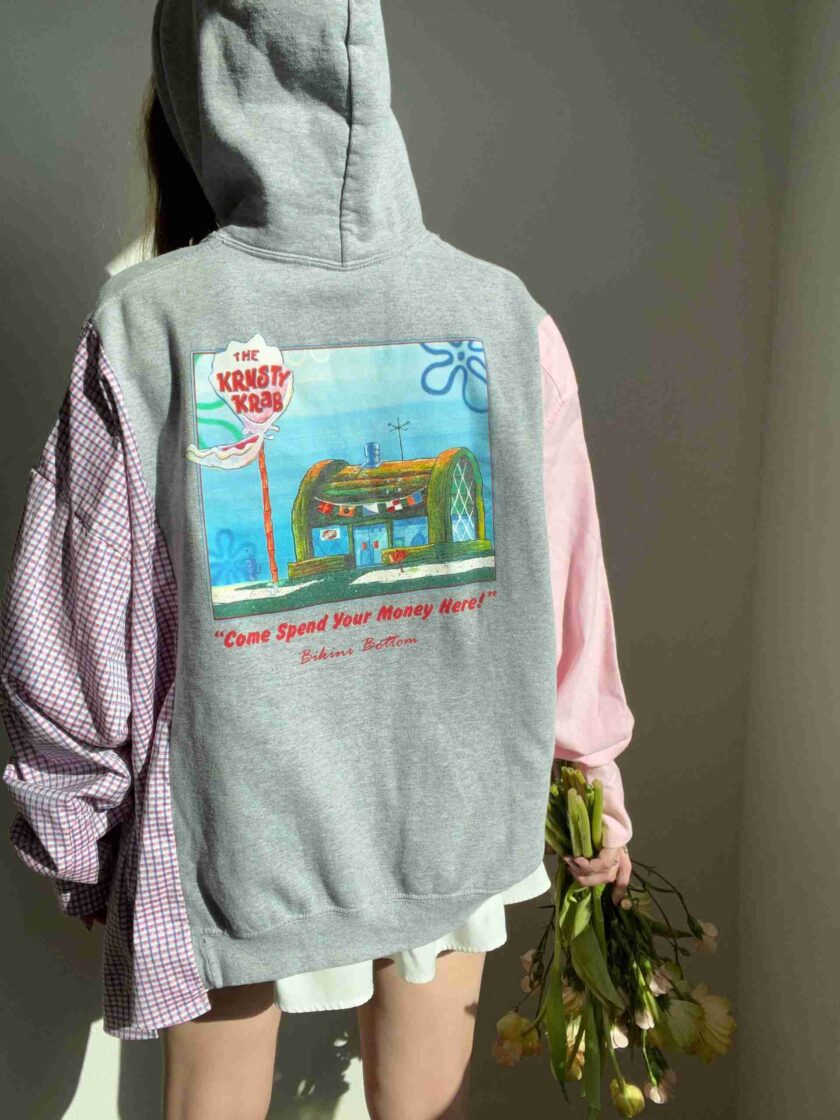 a person wearing a hoodie with a picture of a train on it.