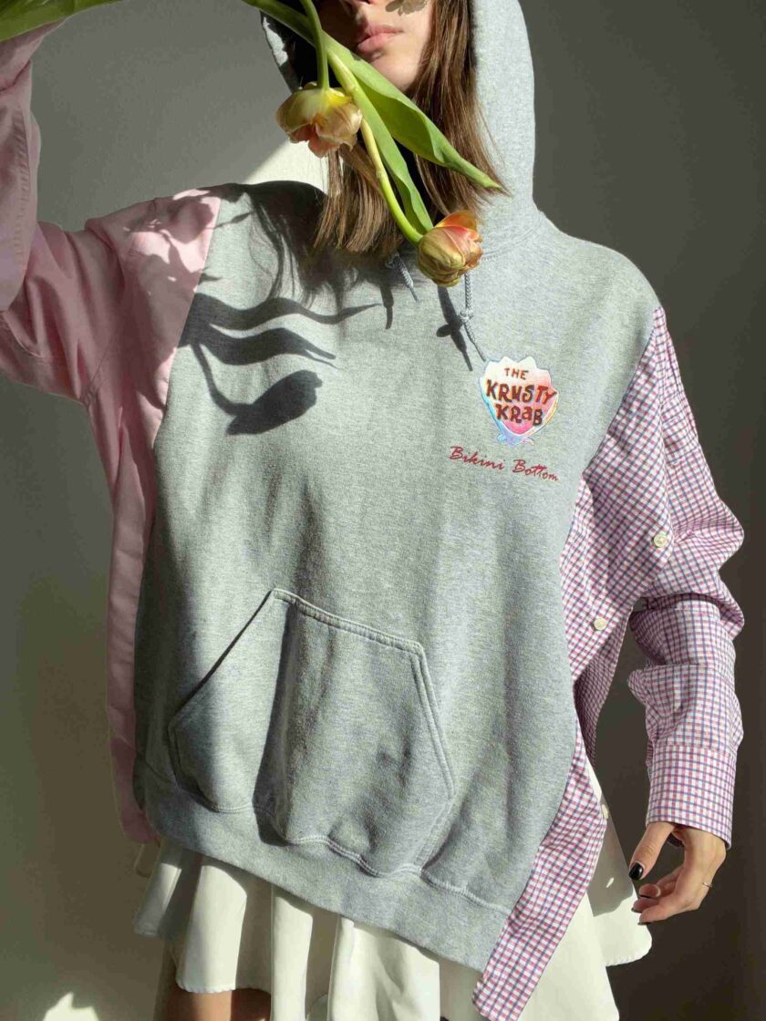 a woman wearing a hoodie with flowers on it.