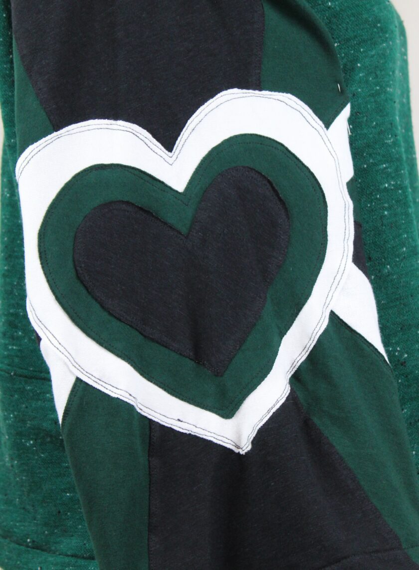 a green and black shirt with a heart cut out of it.