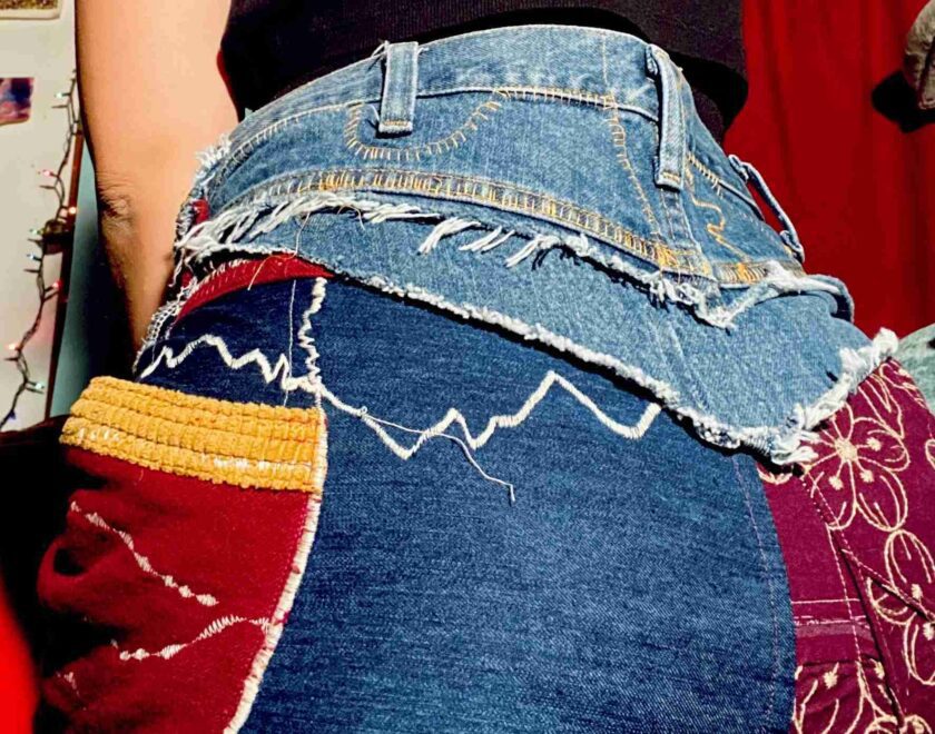 the back of a woman's jean skirt with a patchwork design.