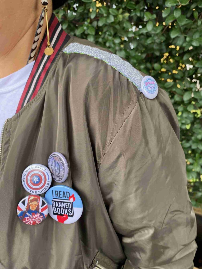 a person wearing a jacket with a bunch of buttons on it.