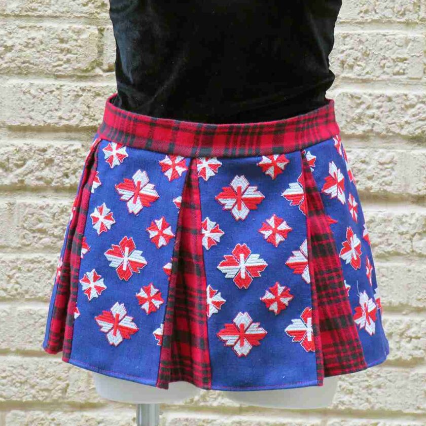 a woman wearing a red, white and blue plaid kilt.