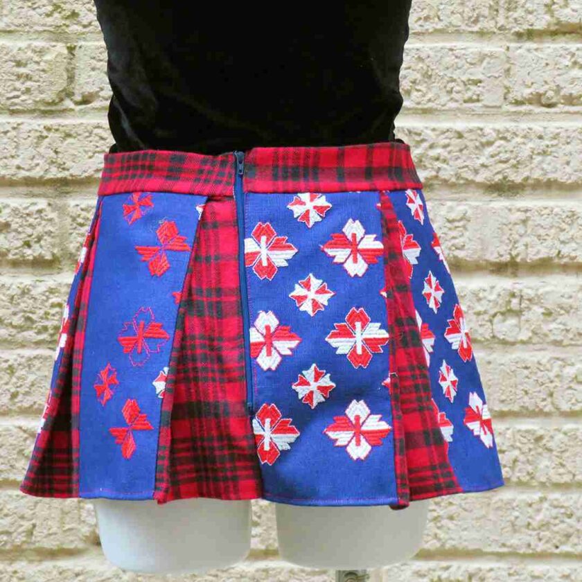 a woman wearing a red and blue plaid kilt.
