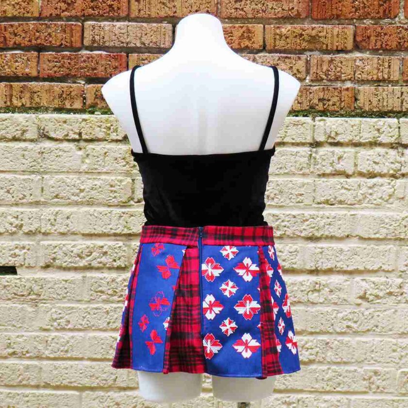 a female mannequin wearing a blue and red skirt.