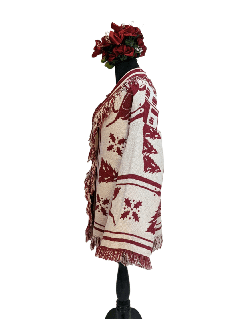 a white and red blanket with a flower on top of it.