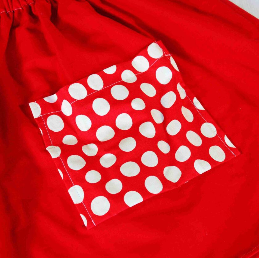 a red dress with white polka dots on it.