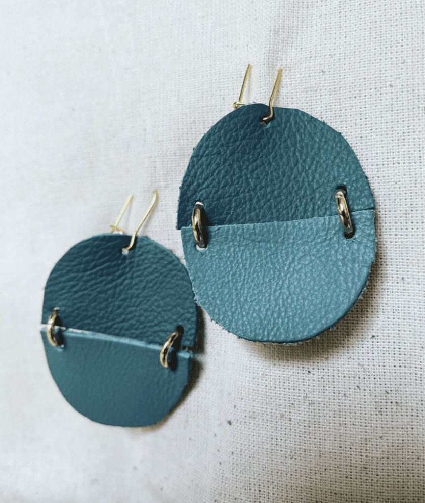 a pair of blue and green leather earrings.
