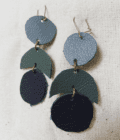 a pair of blue and green leather earrings.