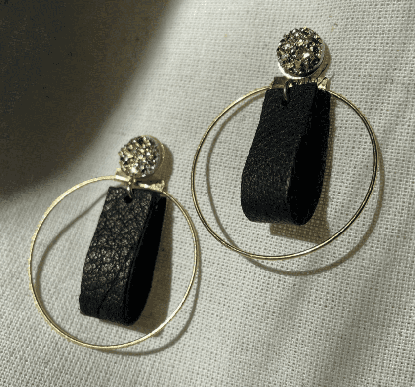 a pair of black and gold hoop earrings.