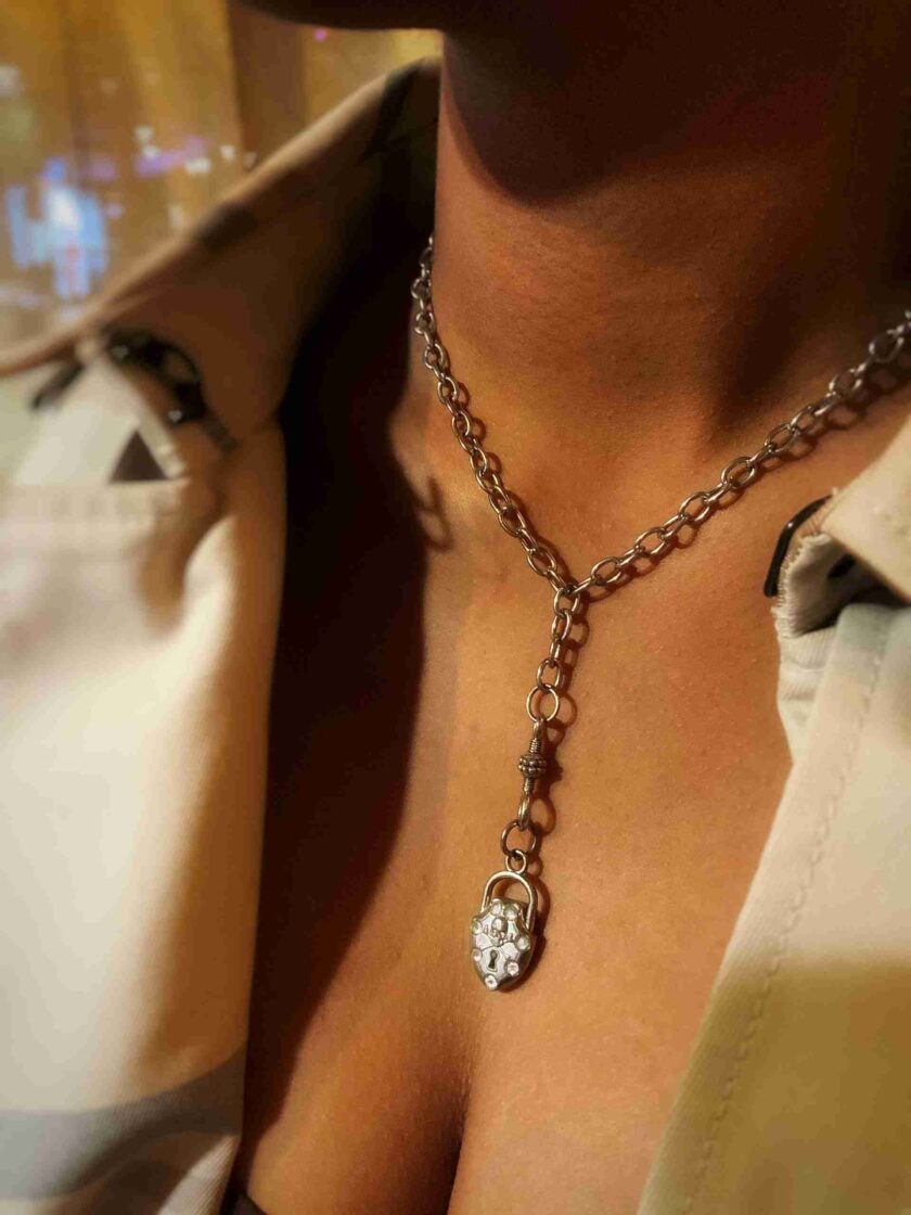 a close up of a person wearing a necklace.