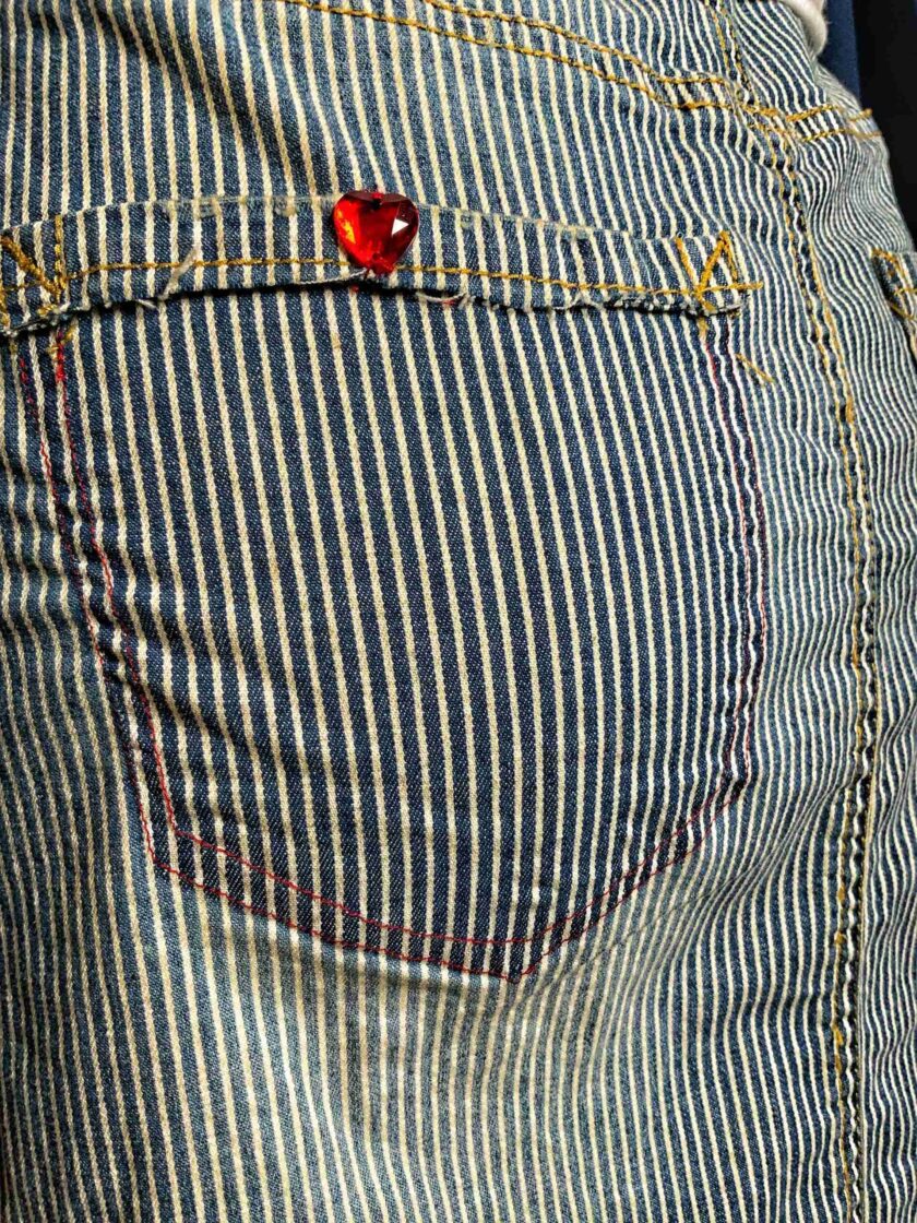a man's jeans with a red heart on it.