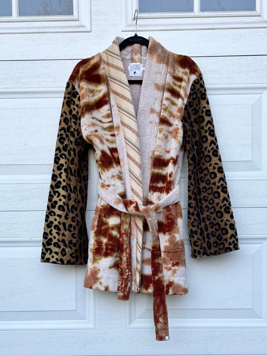 a leopard print robe hanging on a door.