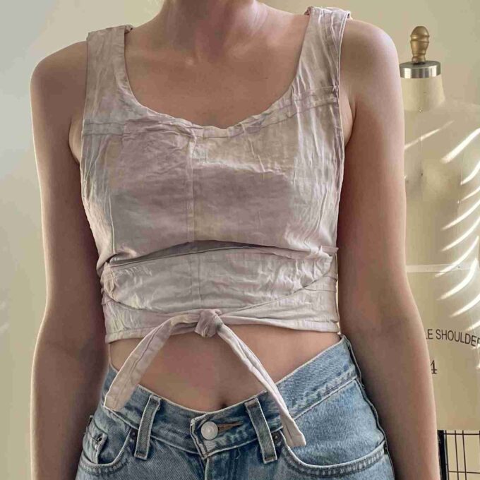 a woman wearing a pair of jeans and a tank top.