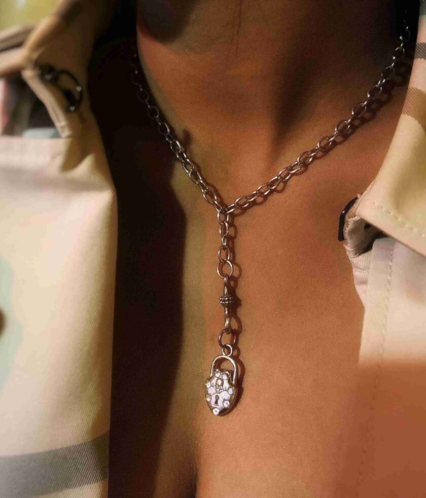 a close up of a person wearing a necklace.