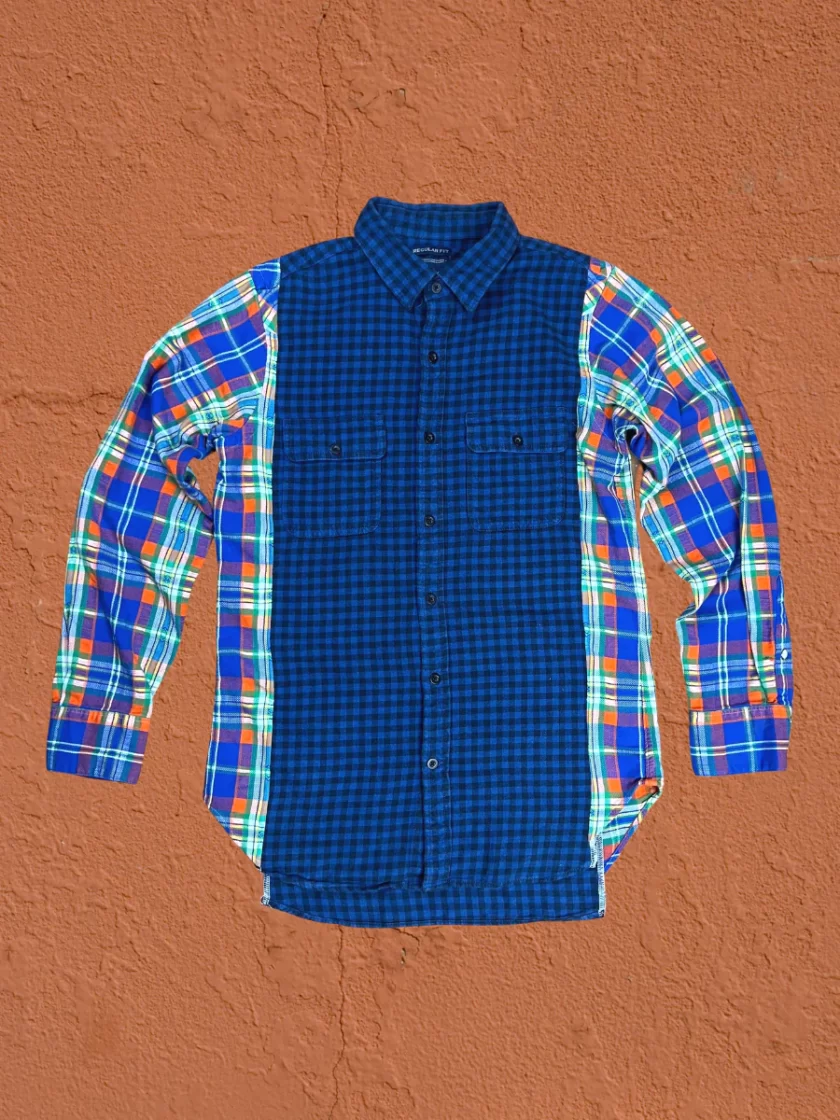 a blue and green plaid shirt hanging on a wall.