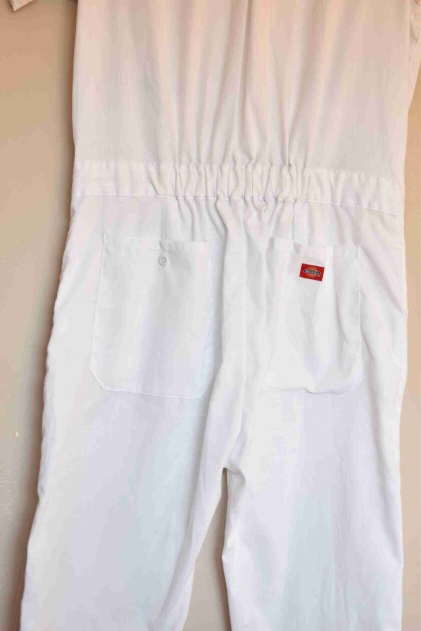 a pair of white pants hanging on a wall.