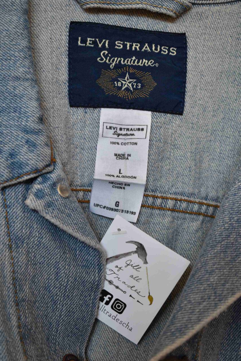 a label on the back of a jean jacket.