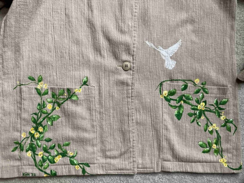 a close up of a shirt with a bird on it.