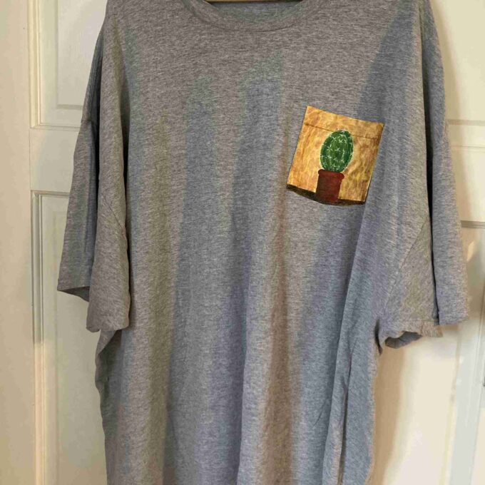 a gray shirt with a cactus pocket on it.