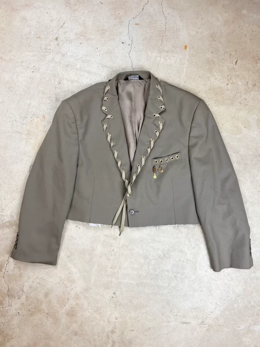 a gray jacket with a tie around it.